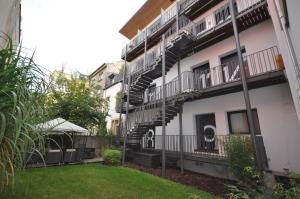 an apartment building with stairs and a yard at Apart2stay in Luxembourg