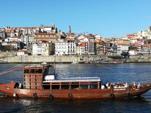 a boat in the water with a city in the background at Near the Airport in Moreira