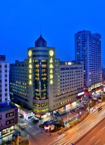 a large building with lights on it in a city at Wenzhou Dongou Hotel in Wenzhou