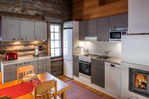 una cucina con tavolo in legno e una sala da pranzo di Holiday Club Ruka Cottages a Oivanki