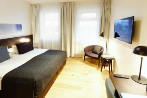 Rúm í herbergi á Fosshotel Reykjavík 