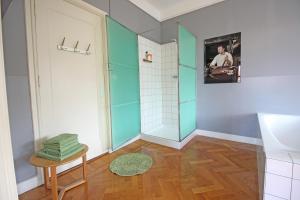 a bathroom with a shower with a glass door at Cafe Modern in Amsterdam