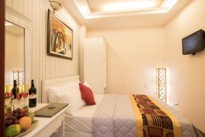 Postel nebo postele na pokoji v ubytování SCAT Hotel- New World Bến Thành