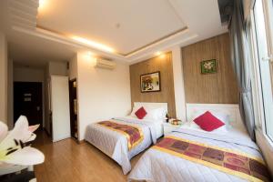 Postel nebo postele na pokoji v ubytování SCAT Hotel- New World Bến Thành