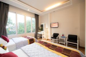 Postel nebo postele na pokoji v ubytování SCAT Hotel- New World Bến Thành