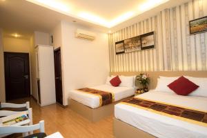 Postel nebo postele na pokoji v ubytování SCAT Hotel- New World Bến Thành