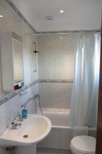 a bathroom with a sink and a tub and a toilet at Casa de Marvila in Santarém +7 photos