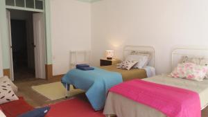 a room with two beds and a room with at Casa de Marvila in Santarém