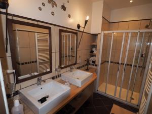 a bathroom with two sinks and a shower at Chateau du Pont Jean in Fresse-sur-Moselle