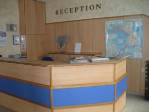 a reception desk in a building with a reception sign at Hotel Astoria in Burgas