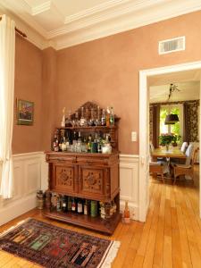 a room with a liquor cabinet with alcohol bottles at Chateau du Pont Jean in Fresse-sur-Moselle +16 photos