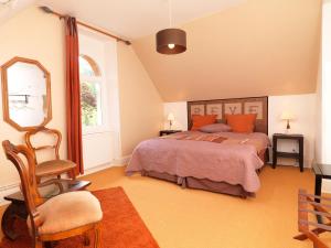 a bedroom with a bed and a chair and a window at Chateau du Pont Jean in Fresse-sur-Moselle