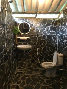 a stone bathroom with a toilet and a sink at Easylife Bungalow in Ko Lanta +94 photos