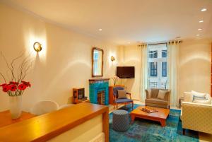 a living room with a couch and a table at Hapimag Apartments Athens in Athens