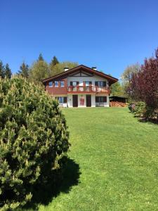a large house with a green lawn in front of it at Green Valley Altopiano di Pinè in Montagnaga