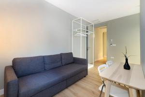 a living room with a couch and a table at Pension Boutique Gomerez Gallegos in Granada