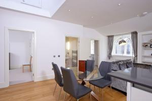 a kitchen with a dining room table and chairs at Destiny Scotland - St Andrew Square Apartments in Edinburgh