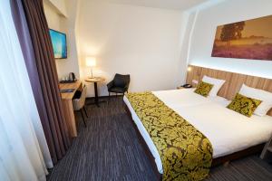 Postel nebo postele na pokoji v ubytování Amrâth Hotel Lapershoek Arenapark
