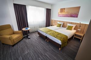 Postel nebo postele na pokoji v ubytování Amrâth Hotel Lapershoek Arenapark