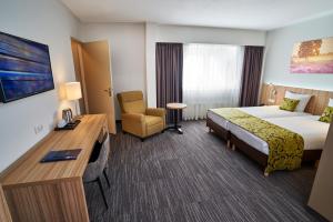 Postel nebo postele na pokoji v ubytování Amrâth Hotel Lapershoek Arenapark