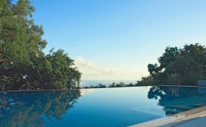 a swimming pool with a view of the ocean at Vallegrande Nature Resort by Geocharme in Cefalù