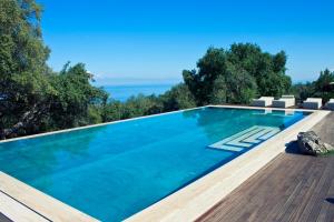 a swimming pool with a view of the ocean at Vallegrande Nature Resort by Geocharme in Cefalù