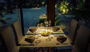 a dining table with a bowl of bananas on it at Vallegrande Nature Resort by Geocharme in Cefalù