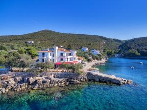 a house on the shore of a body of water at Hotel Timun in Gdinj