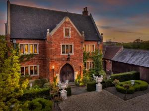 a large brick house with a garden in front of it at Manor Court in Newark upon Trent