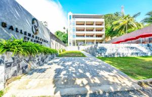 a building with a sign on the side of a road at Ballena Regency in Mirissa
