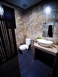 a bathroom with a sink and a toilet at Pround Nan Cottage in Nan +59 photos