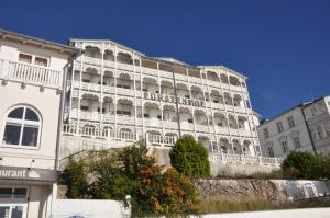 a white building with balconies on the side of it at Fürstenhof Sassnitz in Sassnitz