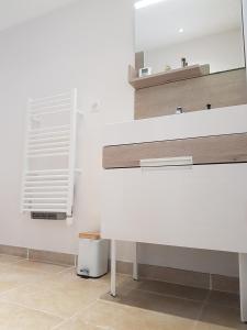 a bathroom with a white sink and a mirror at Séjour Pic Saint Loup in Saint-Mathieu-de-Tréviers