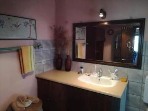 a bathroom with a sink and a mirror at Roula House in Nýmfai