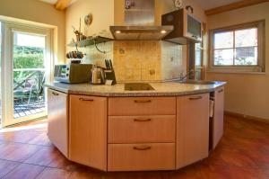 a kitchen with a sink and a counter top at Kotedzas Nidoje in Nida +7 photos