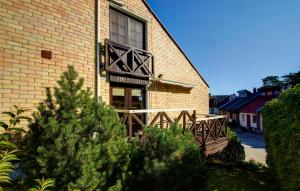 a building with a christmas tree in front of it at Kotedzas Nidoje in Nida