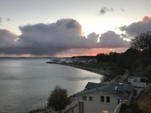a view of a river at sunset with a house at Fürstenhof Sassnitz in Sassnitz