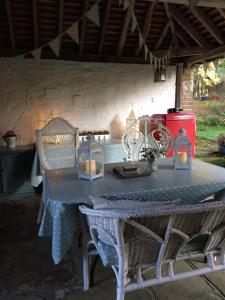 a table with two chairs and candles on it at The Studio @ Great Streele Cottage in Uckfield