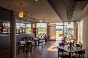 a restaurant with tables and chairs and a bar at PRIMA Inn Ferienwohnungen Seetor Residenz in Neuruppin