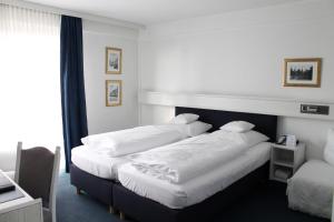 Postel nebo postele na pokoji v ubytování Hotel Windthorst