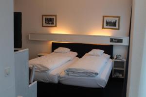 Postel nebo postele na pokoji v ubytování Hotel Windthorst