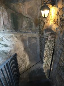 a stairway with a light and a stone wall at Al Castello Affittacamere in Pietra Ligure