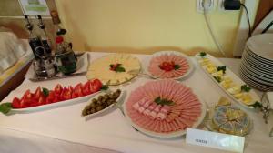 a table with several plates of food on it at B&B Na Kluk in Idrija