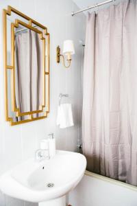 a white bathroom with a sink and a mirror at Mateo Alemán 22 in Seville +85 photos