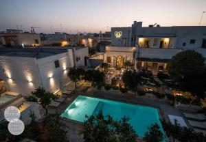 an overhead view of a building with a swimming pool at Palazzo Guglielmo in Vignacastrisi