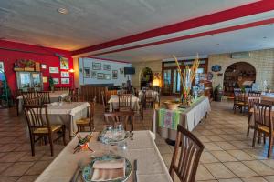 a dining room with tables and chairs in a restaurant at Due Torri in San Severino Marche