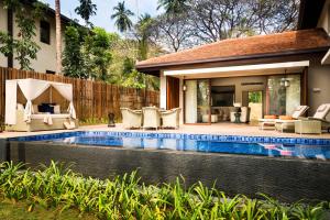 a swimming pool in the backyard of a house at Anantara Peace Haven Tangalle Resort in Tangalle