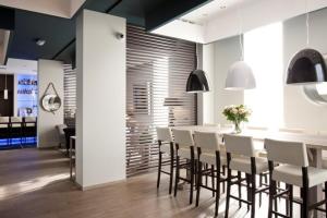 a dining room with a white table and chairs at Blue Woods Hotel - Deerlijk in Deerlijk