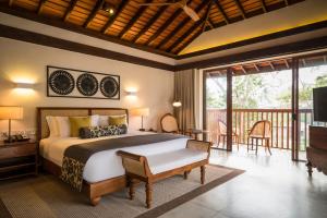 a bedroom with a bed and a balcony at Anantara Peace Haven Tangalle Resort in Tangalle