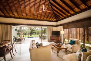 a living room with a couch and a table at Anantara Peace Haven Tangalle Resort in Tangalle